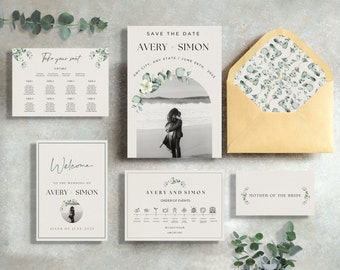 May include: Wedding invitation suite with a eucalyptus and white floral theme. The save the date card features a black and white photo of a couple on a beach. The welcome card has a photo of the couple and the text "Welcome to the wedding of Avery & Simon, Sixth of June 2025". The order of events card has a timeline of the wedding day with icons. The seating chart card has a table layout with the text "Take your seat".