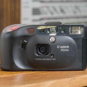 Cámara Canon Sure Shot Ace/Autoboy Prism - Apunta y dispara - Visor de cintura y control remoto - Totalmente funcional y probada