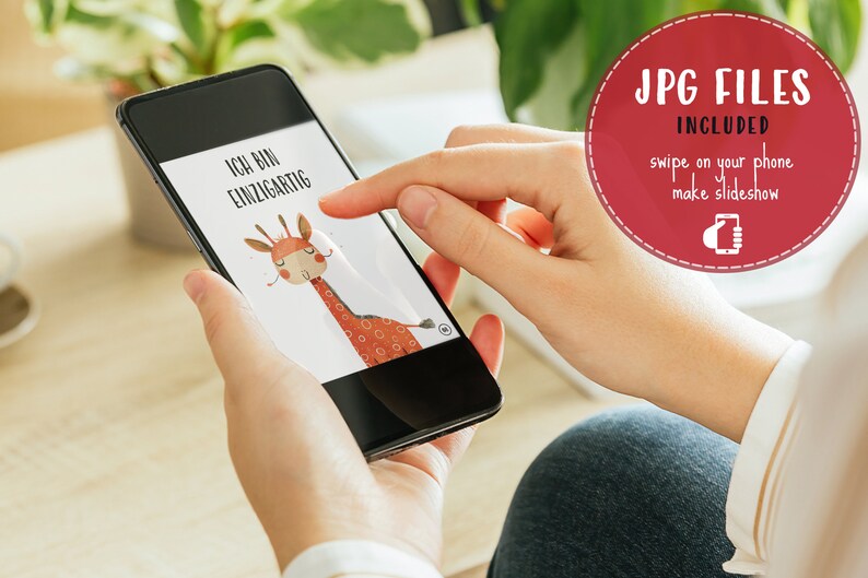 May include: A person is holding a smartphone displaying a digital illustration of a giraffe with the text "Ich bin einzigartig" on a white background.
