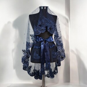 May include: A navy blue bridal veil with beaded lace and a matching satin ribbon.