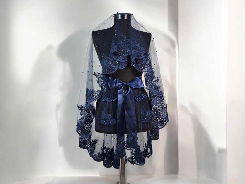 May include: A navy blue bridal veil with beaded lace and a matching satin ribbon.