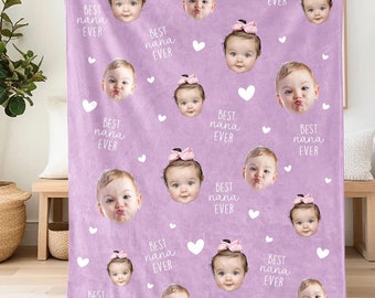 May include: A purple fleece blanket with a repeating pattern of white hearts and the text "BEST nana EVER". The blanket features multiple photos of babies with bows in their hair.