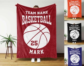 May include: Red fleece blanket with a white basketball graphic and the text "TEAM NAME BASKETBALL 25 MARK".