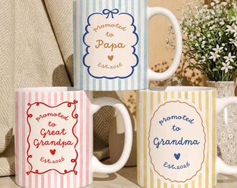 May include: Three ceramic mugs with vertical stripes in light blue, pink, and yellow. Each mug features a central decorative frame with the text "promoted to" followed by "Papa", "Great Grandpa", or "Grandma", and "Est. 2026".