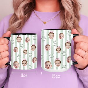 May include: Two white ceramic mugs with black handles and rims. The mugs feature a repeating pattern of baby faces and the text "Best Nana Ever" on a light green striped background. One mug is 11oz, the other is 15oz.