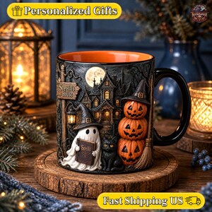 May include: A black ceramic mug with an orange interior featuring a 3D-style relief design of a haunted house, a ghost holding a book labeled Spells, a black cat, and a stack of three jack-o'-lanterns. A sign on the house reads Sophia's House.