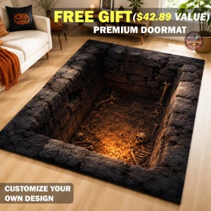 May include: A rectangular doormat featuring a 3D optical illusion print of a deep, dark stone pit or dungeon floor. The design displays weathered gray stone walls, scattered human bones, and two skulls resting on a dirt-covered ground surface.