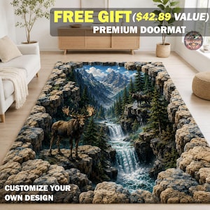 May include: A rectangular area rug featuring a 3D-style landscape print of a mountain valley with a waterfall, evergreen trees, and two moose standing on rocky cliffs. The border of the rug is designed to look like a frame of stacked grey stones.