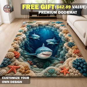 May include: A rectangular doormat featuring a 3D-style print of an underwater scene with three sharks swimming in a deep blue ocean trench surrounded by textured beige rock formations, colourful coral reefs, and orange starfish accents.