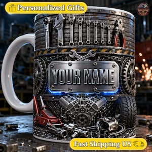 May include: A ceramic mug featuring a mechanical theme with a central metal plate displaying the text YOUR NAME. The design includes various tools like wrenches, a car engine, a red hydraulic jack, a tyre, and gears on a dark textured background.