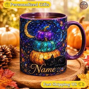 May include: A purple ceramic mug featuring a stained-glass style design of three stacked pumpkins in purple, teal, and orange, with a black cat resting at the base. The design includes a crescent moon and the word Name in gold script lettering.