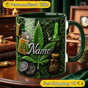 May include: A dark green ceramic mug featuring a large central cannabis leaf graphic with the word Name in silver script. The design includes a gold lighter, a green glass bong, a metal grinder, and a small jar filled with dried plant buds.