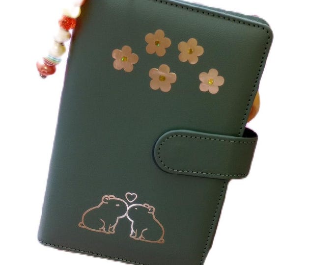 12 month annual saver binder capybara themed. save 1380 over 12 months. matching vellums for each tracker card in bright vibrant designs.