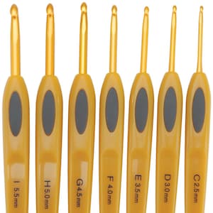 May include: Set of seven crochet hooks with gold-colored metal hooks and yellow handles. Each handle has a gray oval grip and is labeled with a size in millimeters, ranging from 2.5 mm to 5.5 mm.