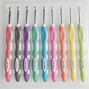 May include: Set of 10 colorful crochet hooks with white polka dots. The hooks are made of metal and have a plastic handle. The sizes of the hooks are labeled on the handles: B-2.0mm, C-2.5mm, D-3.0mm, E-3.5mm, F-4.0mm, G-4.5mm, H-5.0mm, I-5.5mm, J-6.0mm.