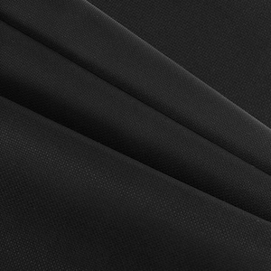 May include: Close-up of black fabric with a subtle textured pattern. The fabric is folded in diagonal lines, creating shadows and highlighting the material's texture. The overall appearance is dark and sleek.