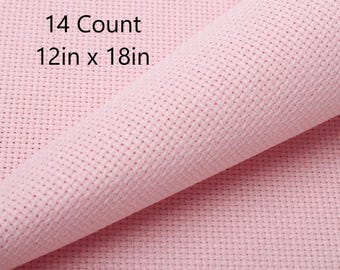 May include: Pink Aida cloth for cross stitch, 14 count, 12 inches by 18 inches.