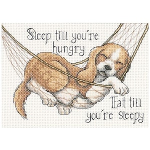 May include: A cross-stitch pattern featuring a cartoon dog sleeping in a hammock with the text "Sleep till you're hungry, Eat till you're sleepy".
