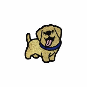 May include: Embroidered patch of a smiling, cartoon-style dog. The dog is light tan with a blue collar and a pink tongue sticking out. The patch has a black outline and is on a white background.