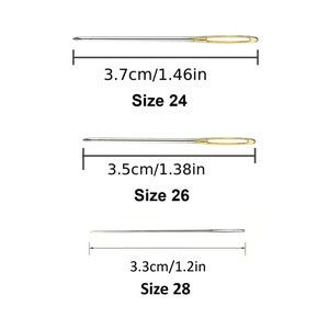 May include: Three needles of different sizes, measured in inches and centimeters. The needles are silver with gold eye tips. The needles are labeled with their sizes: Size 24, Size 26, and Size 28.
