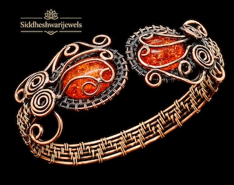 May include: A copper wire-wrapped cuff bracelet featuring two oval-shaped amber stones. The metalwork consists of intricate coils and woven wire patterns. The text Siddheshwarijewels is visible in the upper left corner of the image.