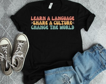 Learn a language share a culture change the world Spanish Teacher Shirt Bilingual Teacher Dual Language Instruction Teacher Tee