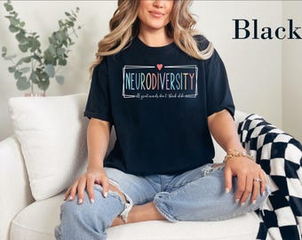 May include: A black short-sleeve t-shirt featuring a rectangular frame with the text NEURODIVERSITY in multicolored letters, a small pink heart above, and the phrase all great minds don't think alike in white script below.
