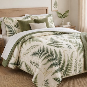 May include: A cream-colored comforter and matching pillow shams featuring a green fern leaf pattern. The bedding set includes two solid olive green square pillows, one small rectangular cream pillow, and a textured olive green throw blanket.