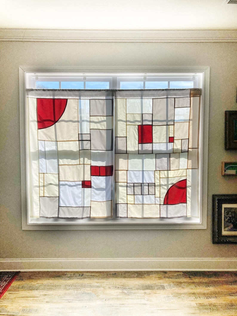 May include: A pair of window curtains featuring a geometric patchwork design composed of rectangular and square panels in white, off-white, and gray, accented by solid red blocks and partial red circular segments outlined in dark gray lines.