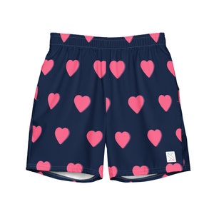 May include: Navy blue athletic shorts with a pink heart pattern.