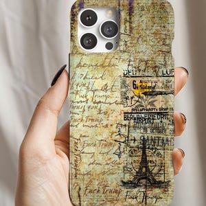 May include: A phone case with a vintage, distressed design. The case features handwritten script, stamps, and the Eiffel Tower. The words "Fuck Trump" are visible throughout the design.