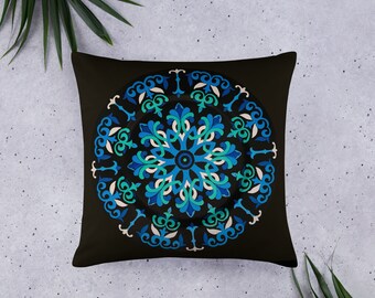 May include: A black throw pillow with a blue and green mandala design. The mandala is intricate and detailed, with a circular pattern of flowers and leaves.