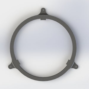May include: A black metal ring with three tabs, designed to hold a speaker in place.