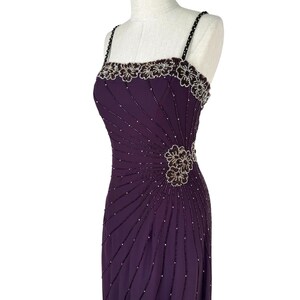Angled view of the purple dress torso, highlighting the radiating beaded pattern and side floral cluster.
