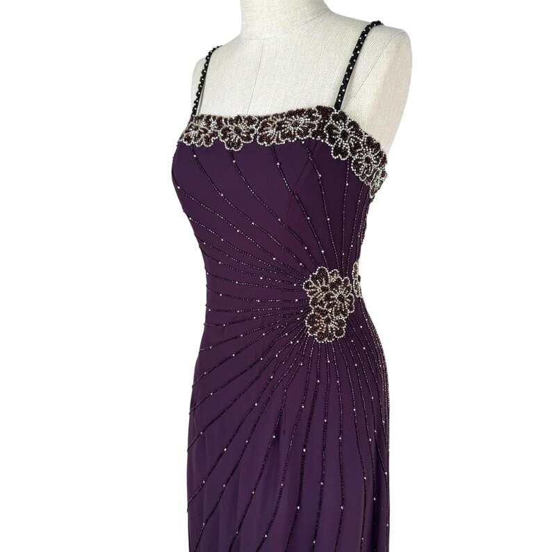 Angled view of the purple dress torso, highlighting the radiating beaded pattern and side floral cluster.