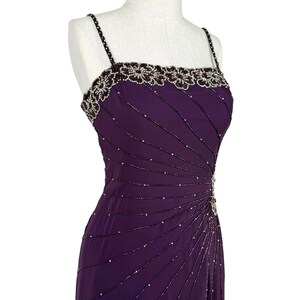 Close-up of the purple dress bodice showing beaded straps and floral neckline embellishments.