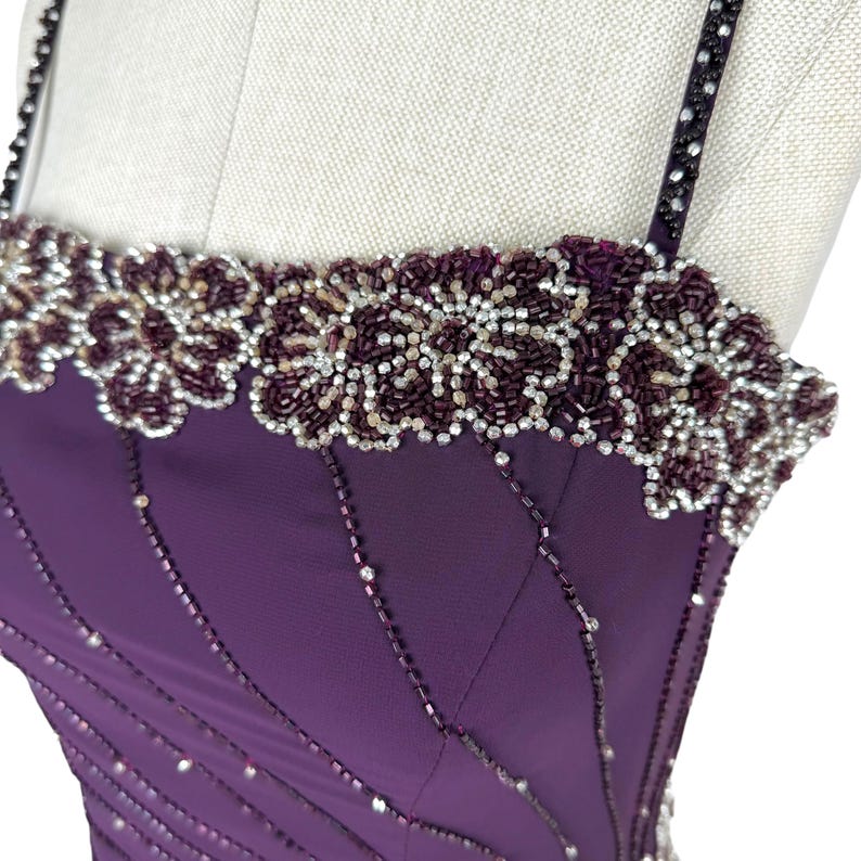 Extreme close-up of the floral beaded trim along the neckline and the beaded straps.