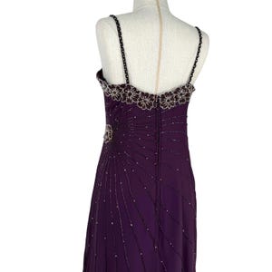 Back view of the purple evening dress on a mannequin from waist to hem.