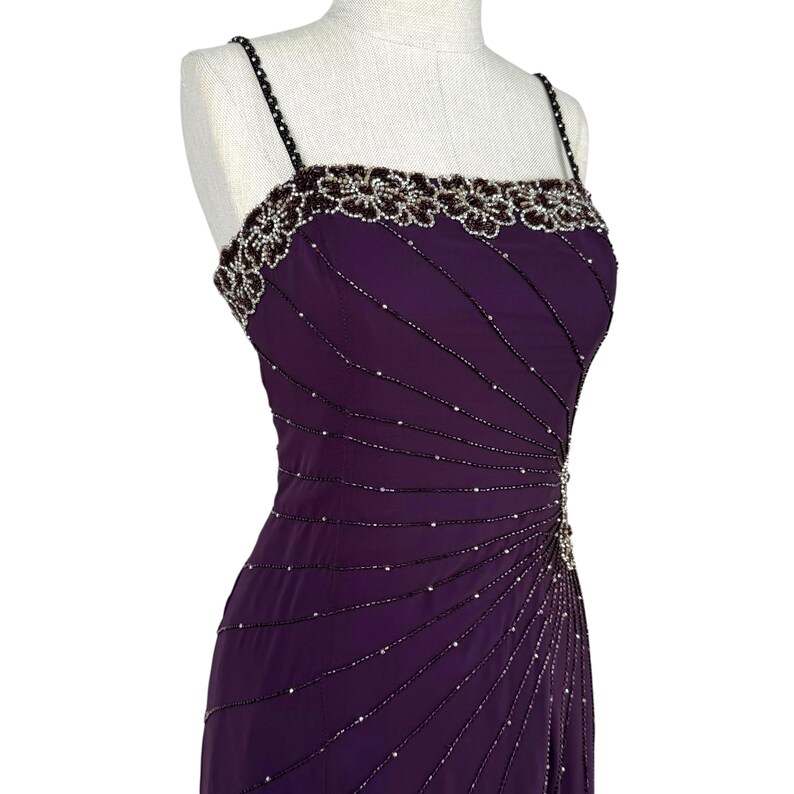 Front-right view of the purple beaded bodice and upper skirt on a mannequin.