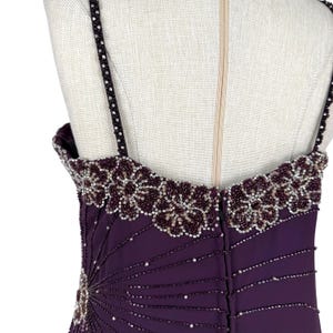 Rear view of the purple gown bodice, showing beaded straps and zipper closure.