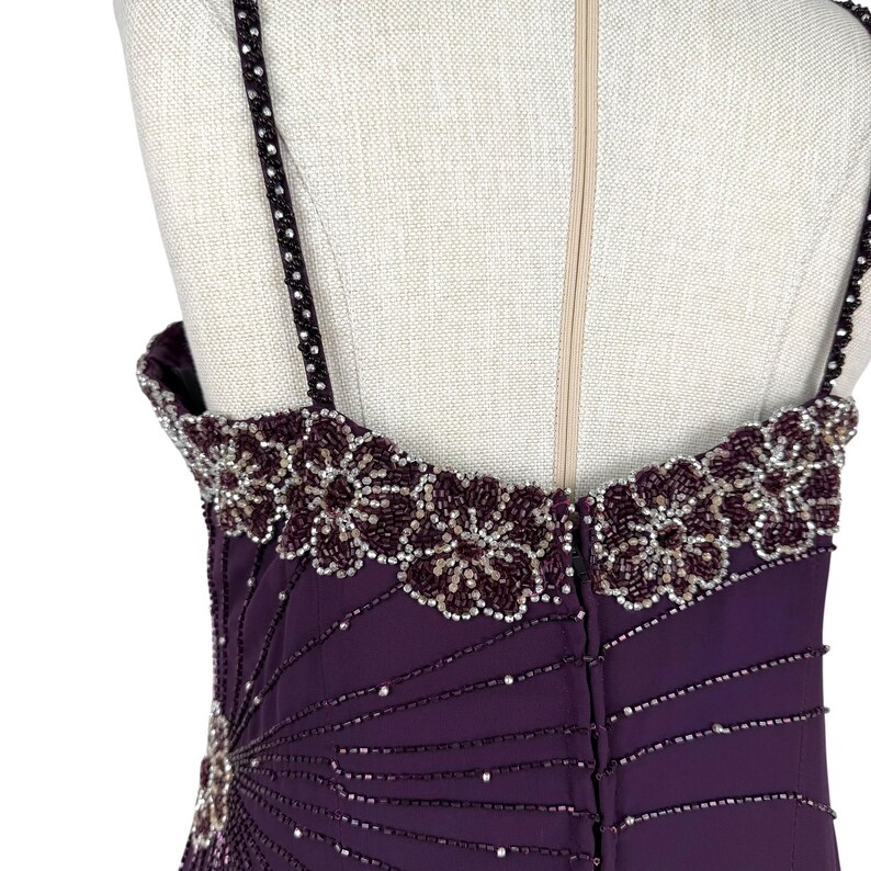 Rear view of the purple gown bodice, showing beaded straps and zipper closure.