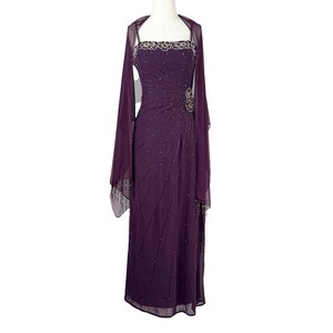 The full-length purple gown paired with a matching sheer shawl on a mannequin.