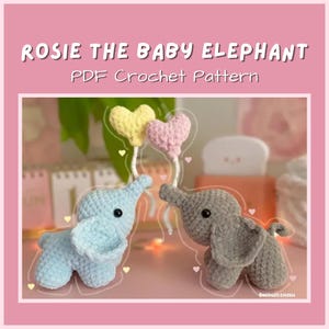 May include: Two crocheted baby elephants, one light blue and one gray, face each other. Each elephant has a large ear and a small trunk. Above them are two heart-shaped decorations, one yellow and one pink. Text reads "Rosie the Baby Elephant PDF Crochet Pattern."