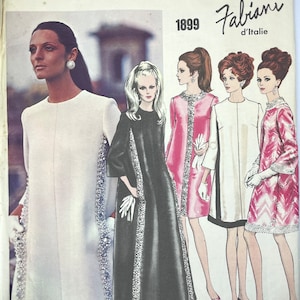 May include: A vintage Vogue Grand Couturier pattern featuring four women's dress designs by Fabiani d'Italie. The pattern number is 1899. The dresses are in various colours and styles, including a white dress with a beaded trim, a black dress with a beaded trim, a pink dress with a white trim, and a pink and white patterned dress.