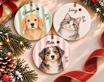 May include: Three round ceramic ornaments featuring illustrations of pets. One shows a golden retriever named Charlie on green stripes, one a cat named Lucy, and one a tri-colour dog named Max on pink stripes. Each includes paw and heart icons.