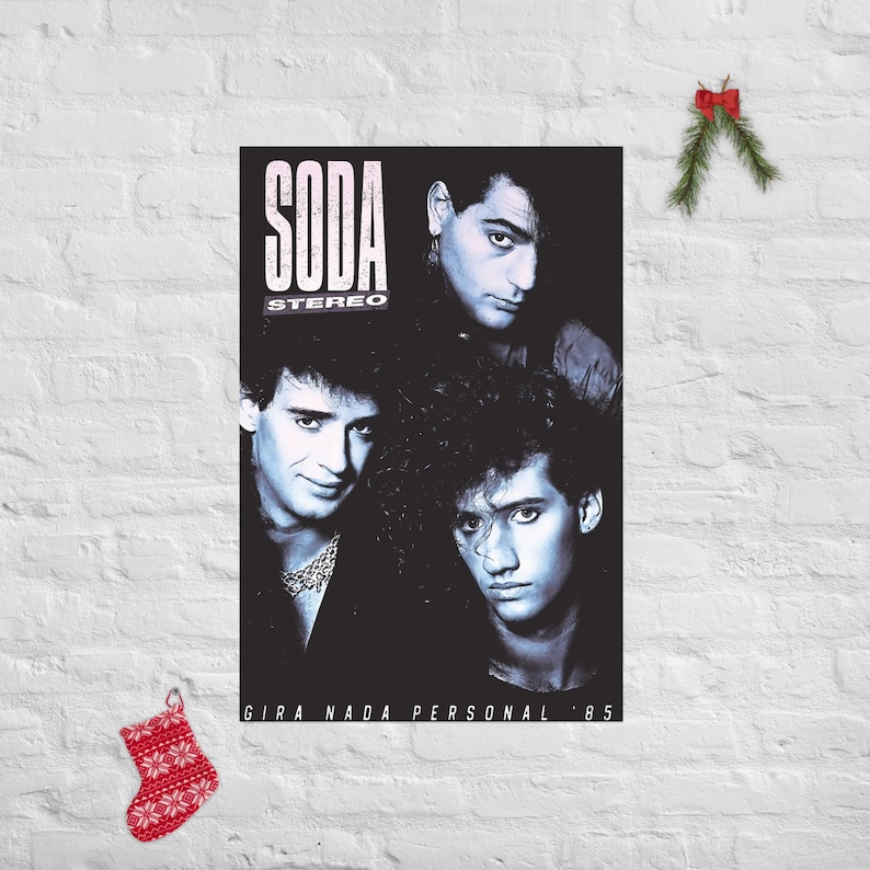 May include: A rectangular poster featuring a black and white photograph of three band members. The text SODA STEREO is printed in white at the top left, and the text GIRA NADA PERSONAL '85 is printed in white at the bottom of the poster.