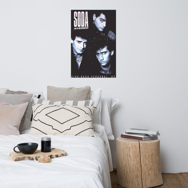May include: A rectangular black and white poster featuring a portrait of the band Soda Stereo. The text SODA STEREO appears at the top left, and the text GIRA NADA PERSONAL 85 is printed at the bottom of the poster in a white sans-serif font.