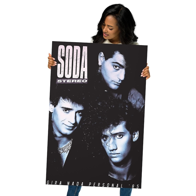May include: A rectangular poster featuring a black and white photograph of three band members. The text SODA STEREO is printed in the upper left corner, and the text GIRA NADA PERSONAL 85 is printed along the bottom edge of the poster.