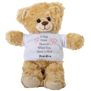 May include: A brown teddy bear wearing a white t-shirt with the text "A Hug From Heaven When You Need it Most Grandma" and red hearts.