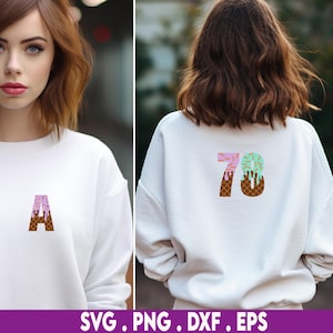 May include: White sweatshirt with a pink and green ice cream cone design featuring the number 78. The ice cream cone is decorated with sprinkles and a brown waffle cone.